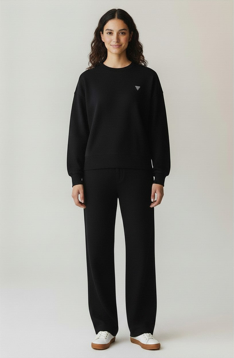 BubiniSegreti black cotton oversized sweatshirt and matching trousers worn by a model with white sneakers
