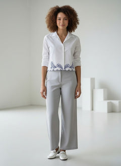 BubiniSegreti white cotton shirt with blue paisley embroidery and lace trim worn by a model with curly hair